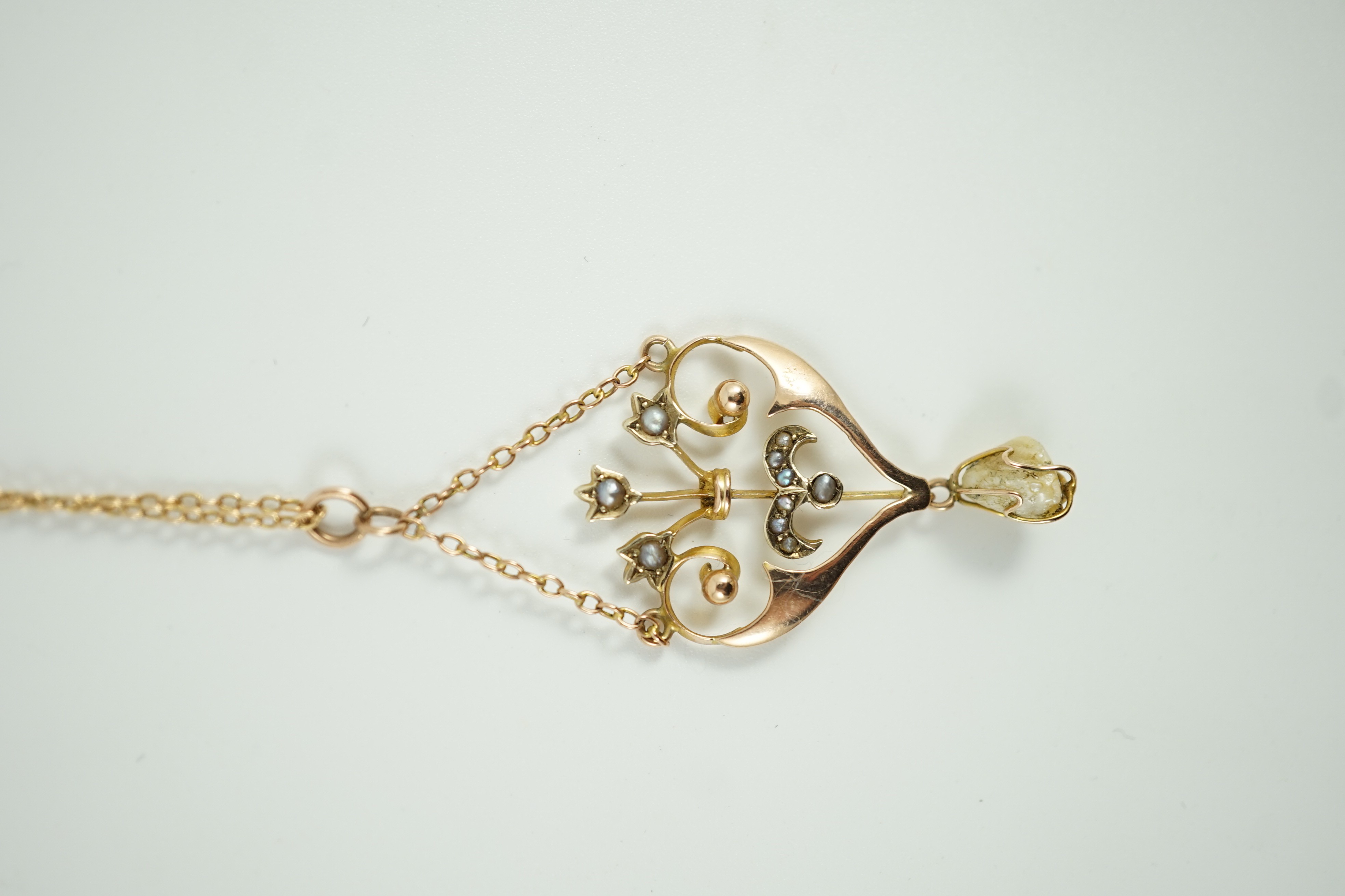 An Edwardian 9ct, baroque and seed pearl set drop pendant necklace, 47cm, gross weight 4.3 grams.